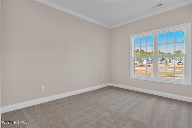 carpeted spare room with visible vents, ornamental molding, and baseboards