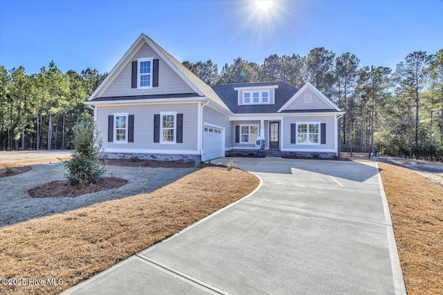 view of front facade with concrete driveway, an attached garage, and a front yard