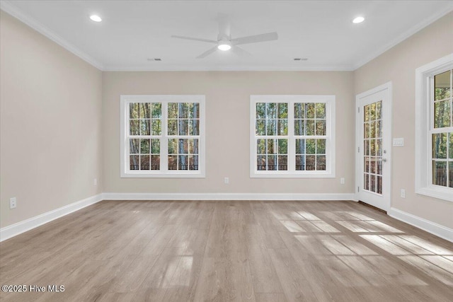 empty room featuring baseboards, recessed lighting, light wood-type flooring, and crown molding