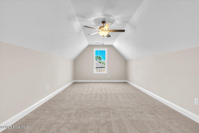 bonus room with lofted ceiling, carpet floors, baseboards, and a ceiling fan