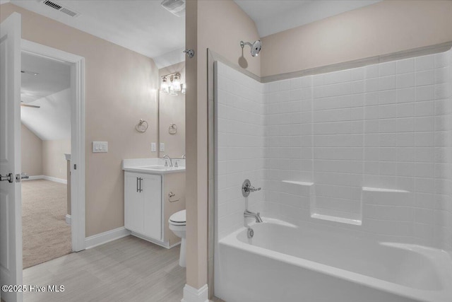 bathroom with baseboards, visible vents, bathing tub / shower combination, toilet, and vanity