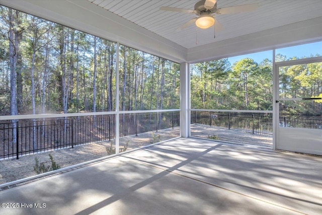 unfurnished sunroom with ceiling fan