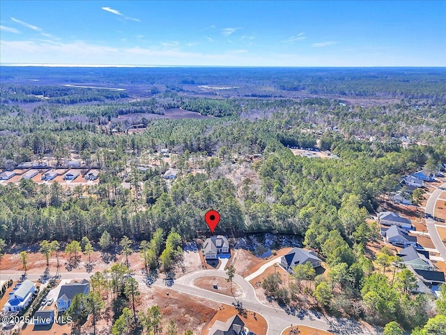 drone / aerial view with a wooded view