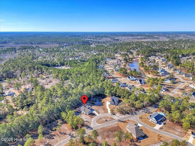 drone / aerial view featuring a forest view