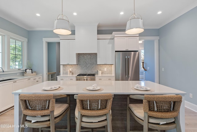 3617 Barnesmore Dr, Castle Hayne, NC 28429 - kitchen with appliances with stainless steel finishes, backsplash, light countertops, a kitchen breakfast bar, and recessed lighting