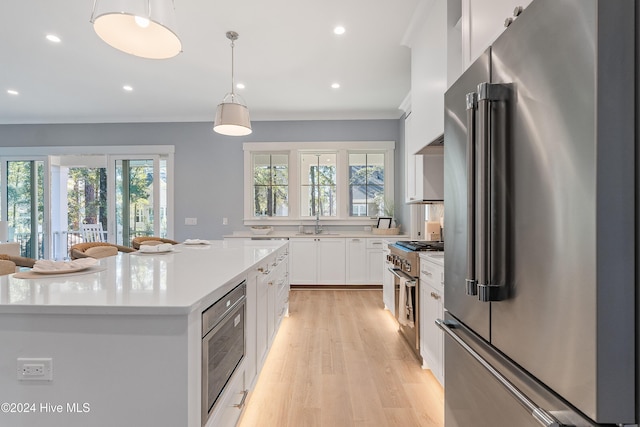 3617 Barnesmore Dr, Castle Hayne, NC 28429 - kitchen featuring high end appliances, healthy amount of natural light, light countertops, white cabinets, and recessed lighting
