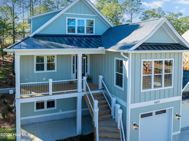 3617 Barnesmore Dr, Castle Hayne, NC 28429 - view of front of home with board and batten siding, a garage, metal roof, and a shingled roof