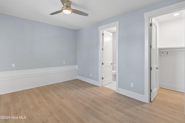 3617 Barnesmore Dr, Castle Hayne, NC 28429 - unfurnished bedroom with light wood-type flooring, baseboards, a walk in closet, and connected bathroom