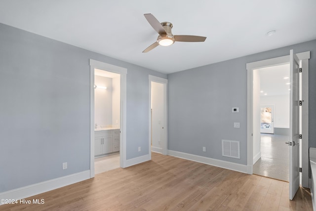 3617 Barnesmore Dr, Castle Hayne, NC 28429 - unfurnished bedroom with light wood-style floors, baseboards, ensuite bathroom, and ceiling fan