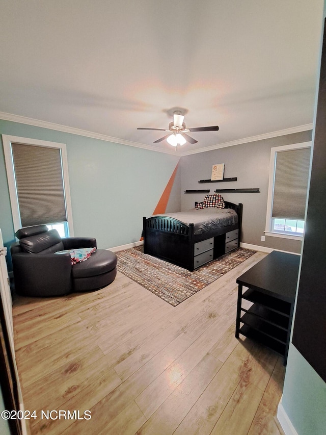 bedroom featuring ceiling fan, light hardwood / wood-style flooring, and ornamental molding