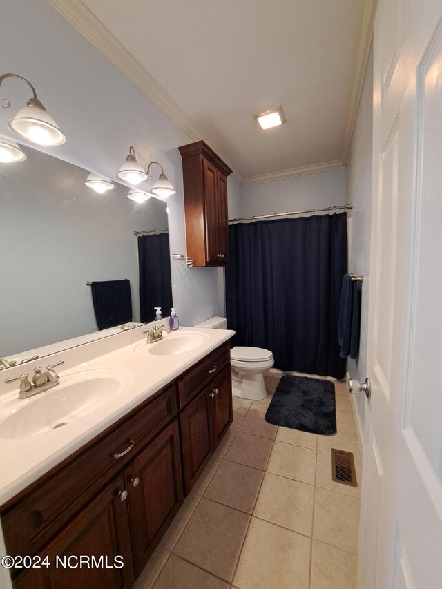 bathroom featuring double vanity, ornamental molding, tile patterned flooring, and toilet