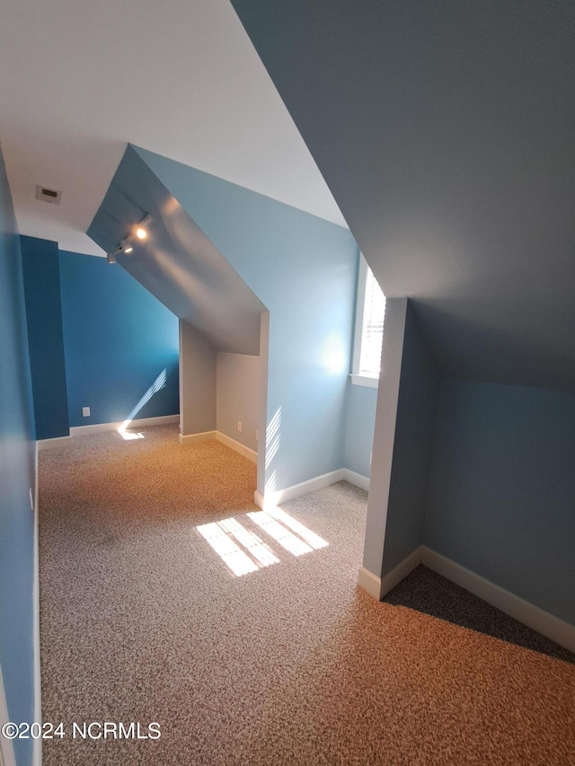 bonus room featuring visible vents, baseboards, carpet flooring, and vaulted ceiling