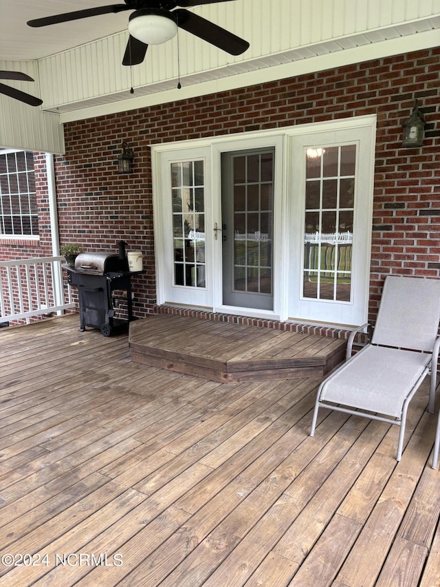 deck with a ceiling fan and area for grilling