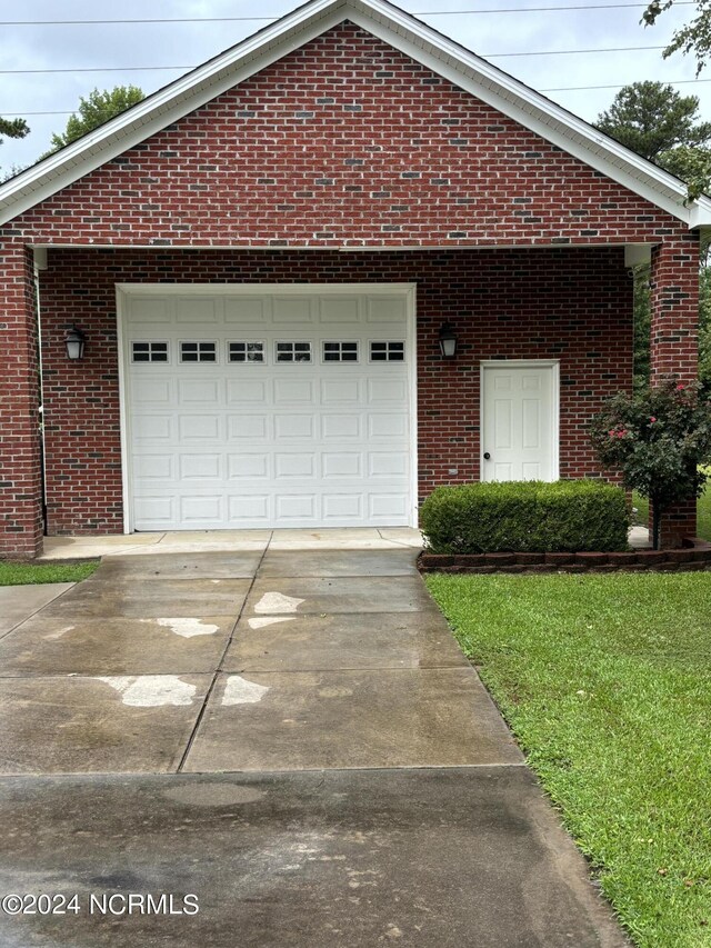 exterior space featuring driveway and brick siding