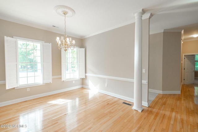 unfurnished room featuring ornate columns, crown molding, and light hardwood / wood-style floors