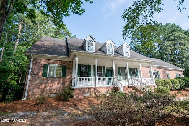 new england style home with covered porch