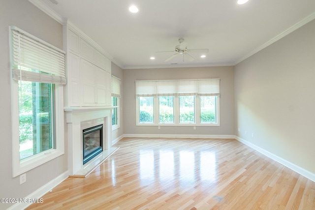 unfurnished living room with light hardwood / wood-style flooring, ceiling fan, and a healthy amount of sunlight