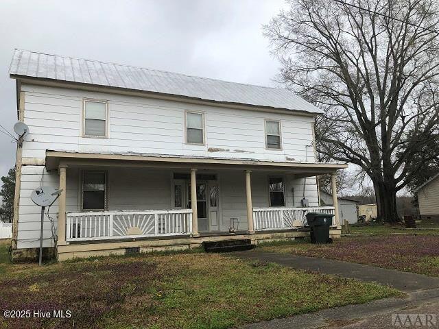 view of front facade with covered porch and metal roof