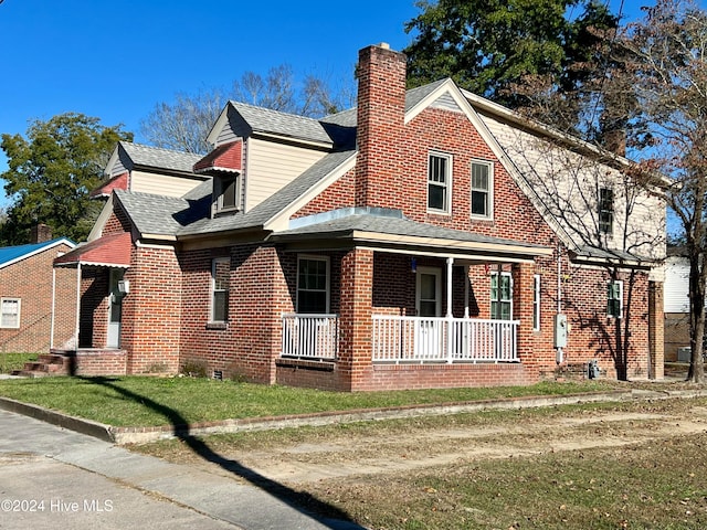 exterior space featuring a yard and covered porch