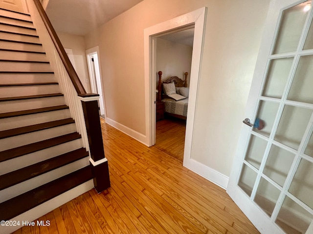 stairway with hardwood / wood-style flooring