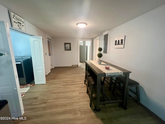 dining room featuring light hardwood / wood-style flooring and washer / dryer