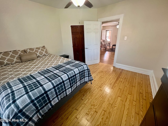 bedroom with ceiling fan and light hardwood / wood-style flooring