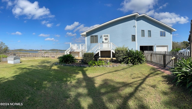 back of house with a yard and a deck