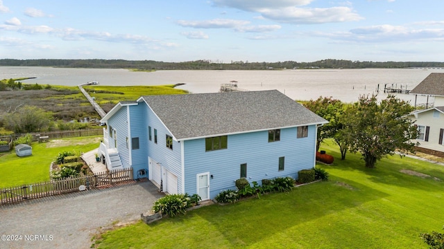 221 Lawrence Rd, Beaufort, NC 28516 - view of front of home featuring roof with shingles, an attached garage, gravel driveway, and a water view