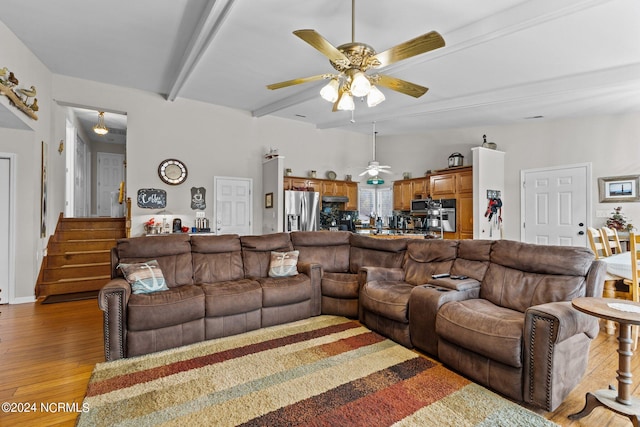 living room with vaulted ceiling with beams, light wood-type flooring, and ceiling fan