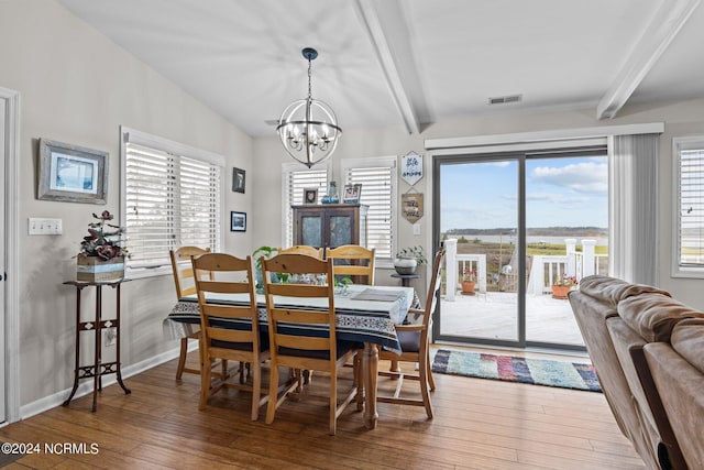 221 Lawrence Rd, Beaufort, NC 28516 - dining space with beamed ceiling, a chandelier, hardwood / wood-style floors, and baseboards