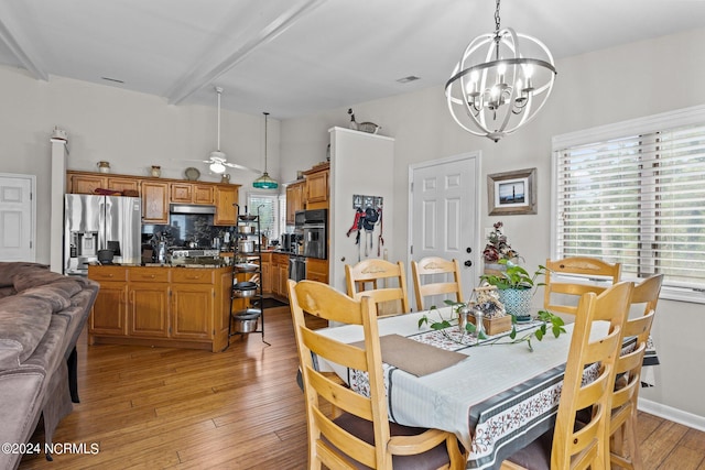 dining area with beam ceiling, light wood-type flooring, and ceiling fan with notable chandelier