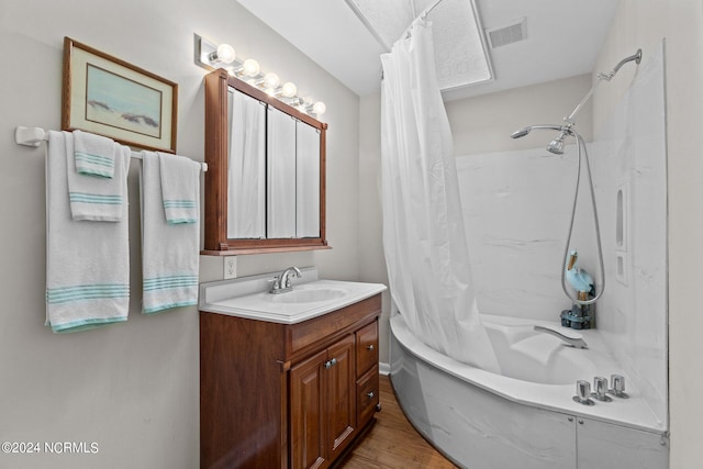 bathroom with vanity, hardwood / wood-style floors, and shower / tub combo with curtain