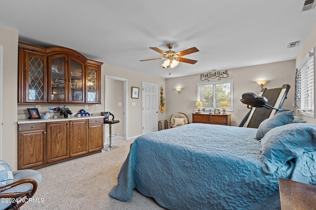 bedroom with light carpet and ceiling fan