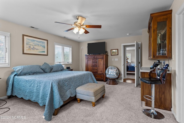 bedroom with light colored carpet and ceiling fan