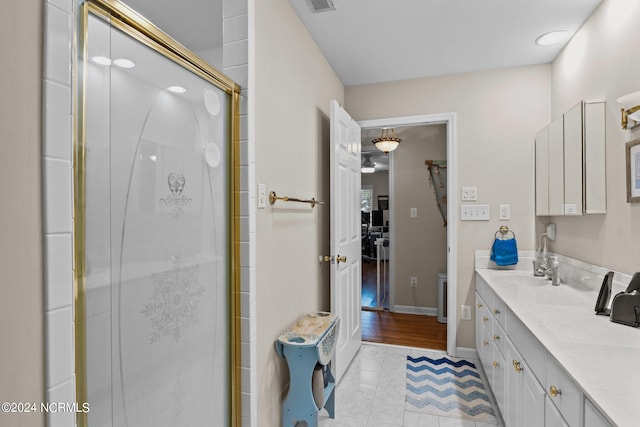 bathroom featuring vanity, walk in shower, and wood-type flooring