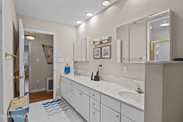 bathroom with vanity, a shower with shower door, and tile patterned floors