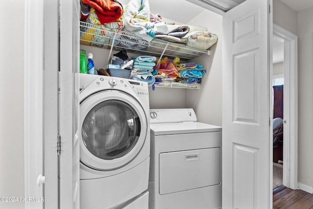 laundry area featuring washer and dryer and hardwood / wood-style flooring