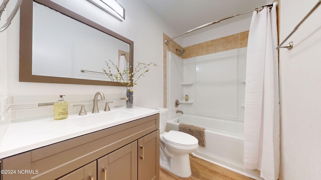 full bathroom featuring hardwood / wood-style flooring, toilet, vanity, and shower / bath combo