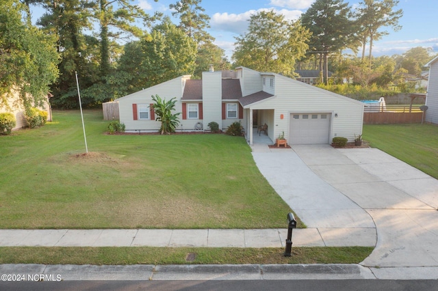 view of front of property with a front lawn and a garage