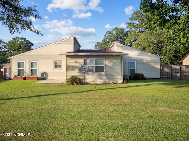 rear view of house with a lawn