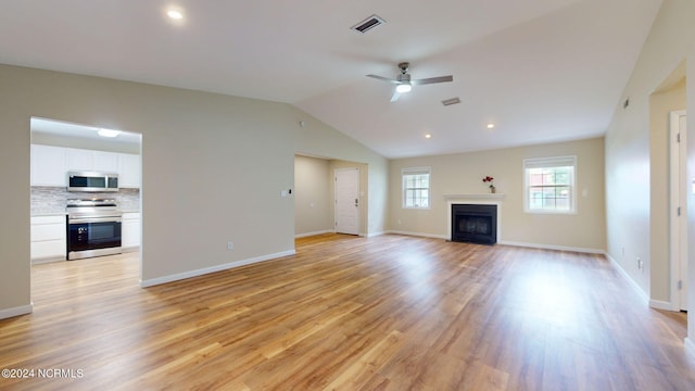 unfurnished living room with ceiling fan, light wood-type flooring, and lofted ceiling