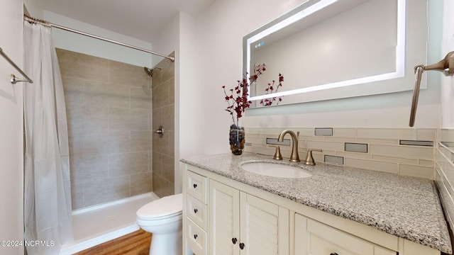 bathroom featuring tile walls, a shower with curtain, backsplash, toilet, and vanity