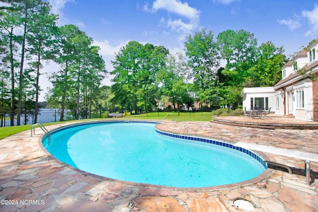 view of swimming pool featuring a patio area