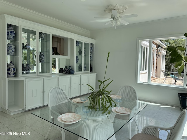 dining room with a healthy amount of sunlight, a ceiling fan, ornamental molding, and light tile patterned flooring