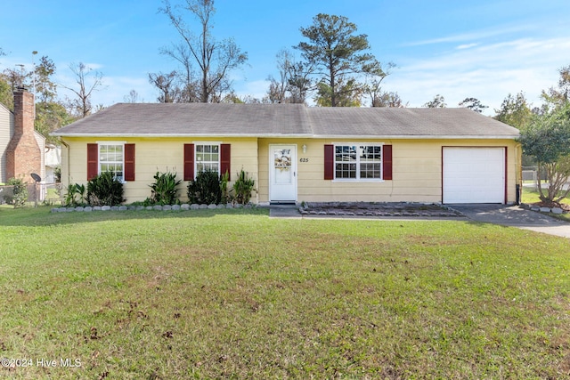 ranch-style house featuring a garage and a front lawn