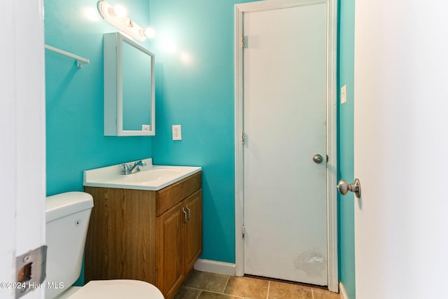 bathroom featuring tile patterned flooring, vanity, and toilet