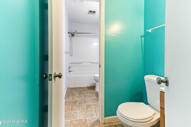 bathroom with tile patterned flooring, toilet, and tub / shower combination