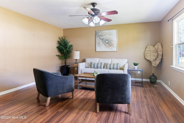 living room featuring ceiling fan and dark wood-type flooring