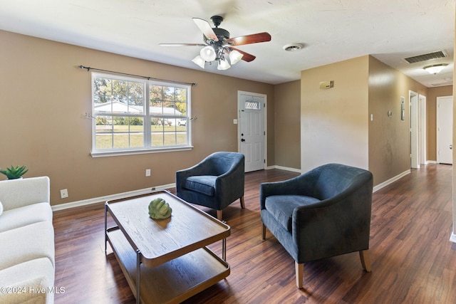 living room featuring ceiling fan and dark wood-type flooring