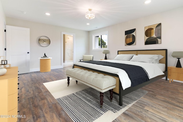 bedroom with dark hardwood / wood-style flooring and ensuite bathroom